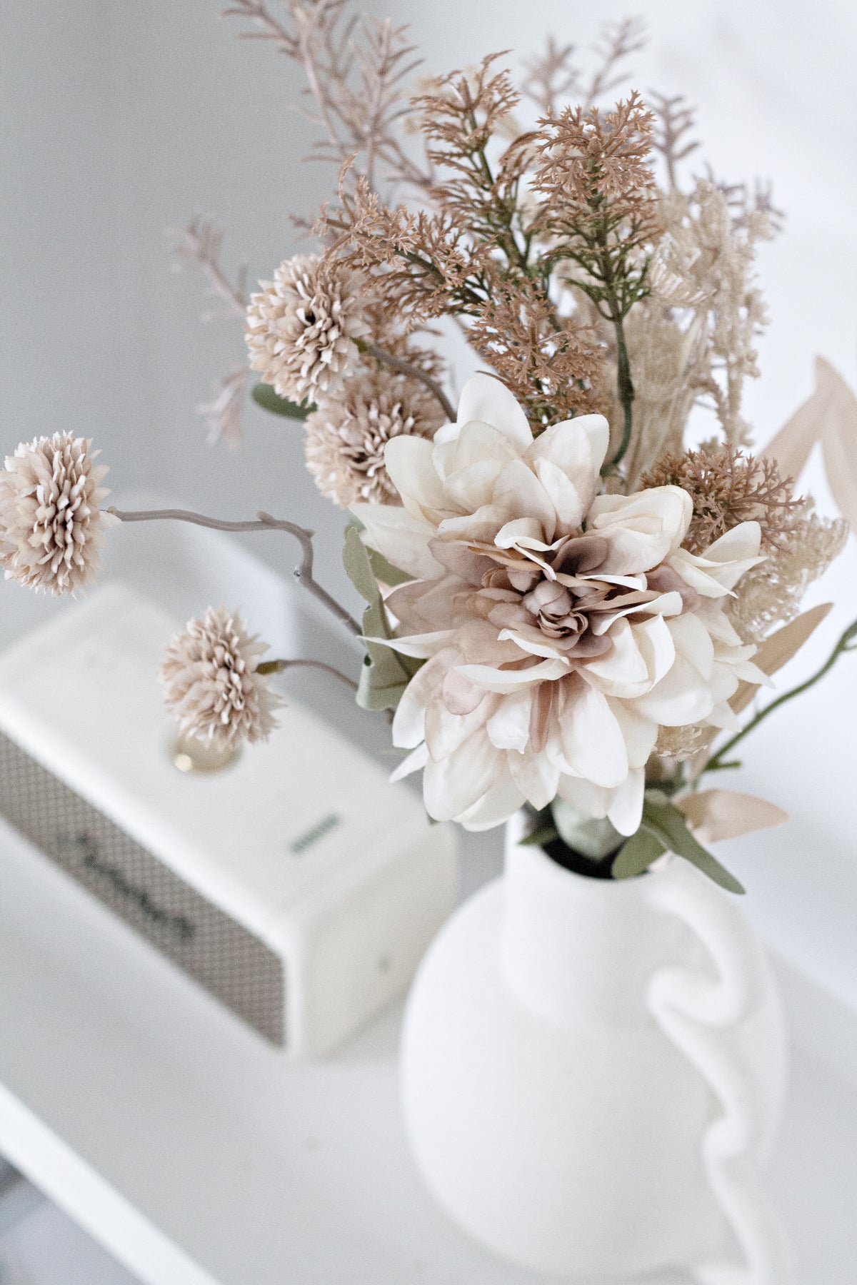 Close view of blush dried florals arranged in the Chloe vase