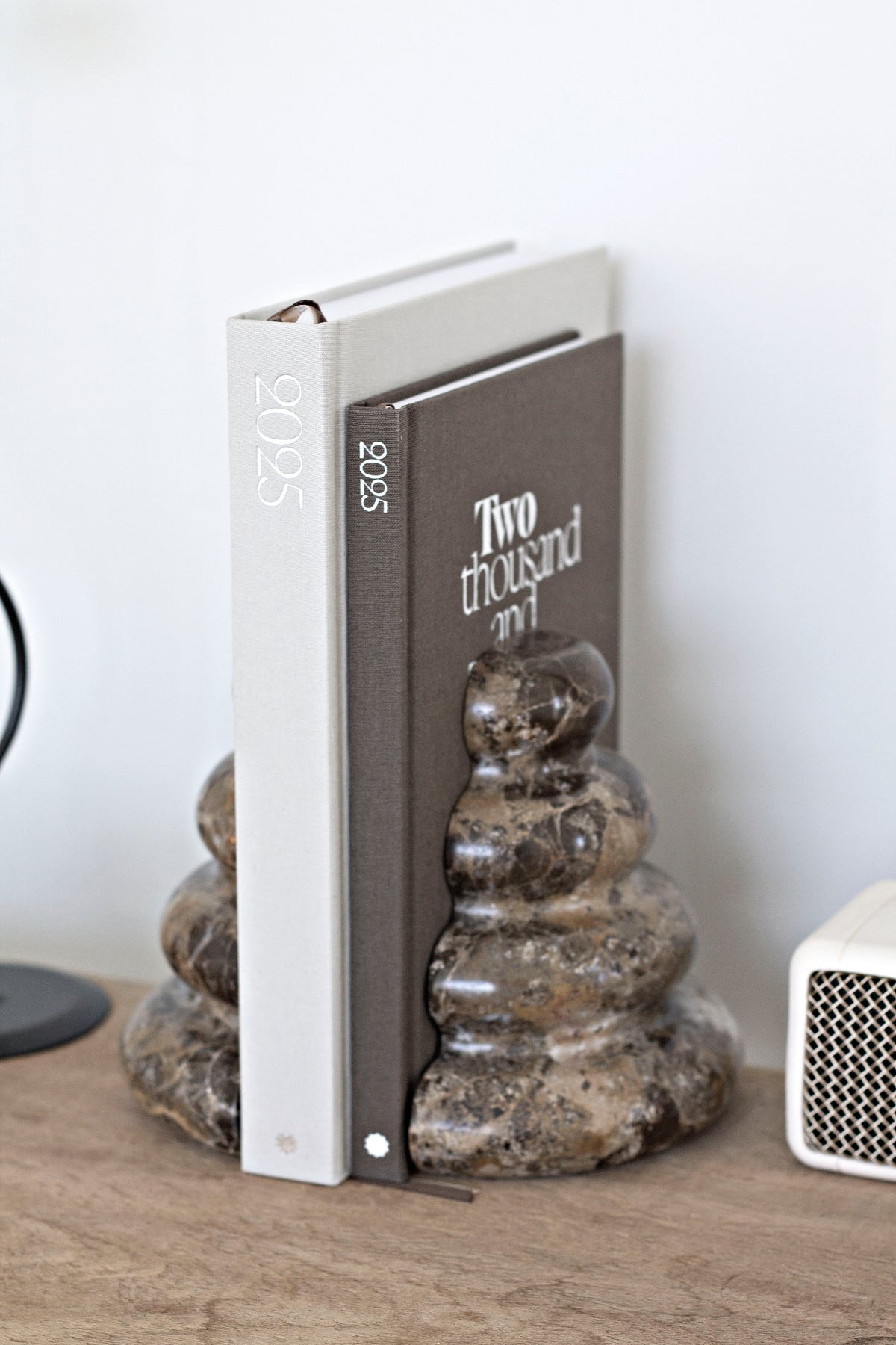 Casa bookend holding books on a timber console