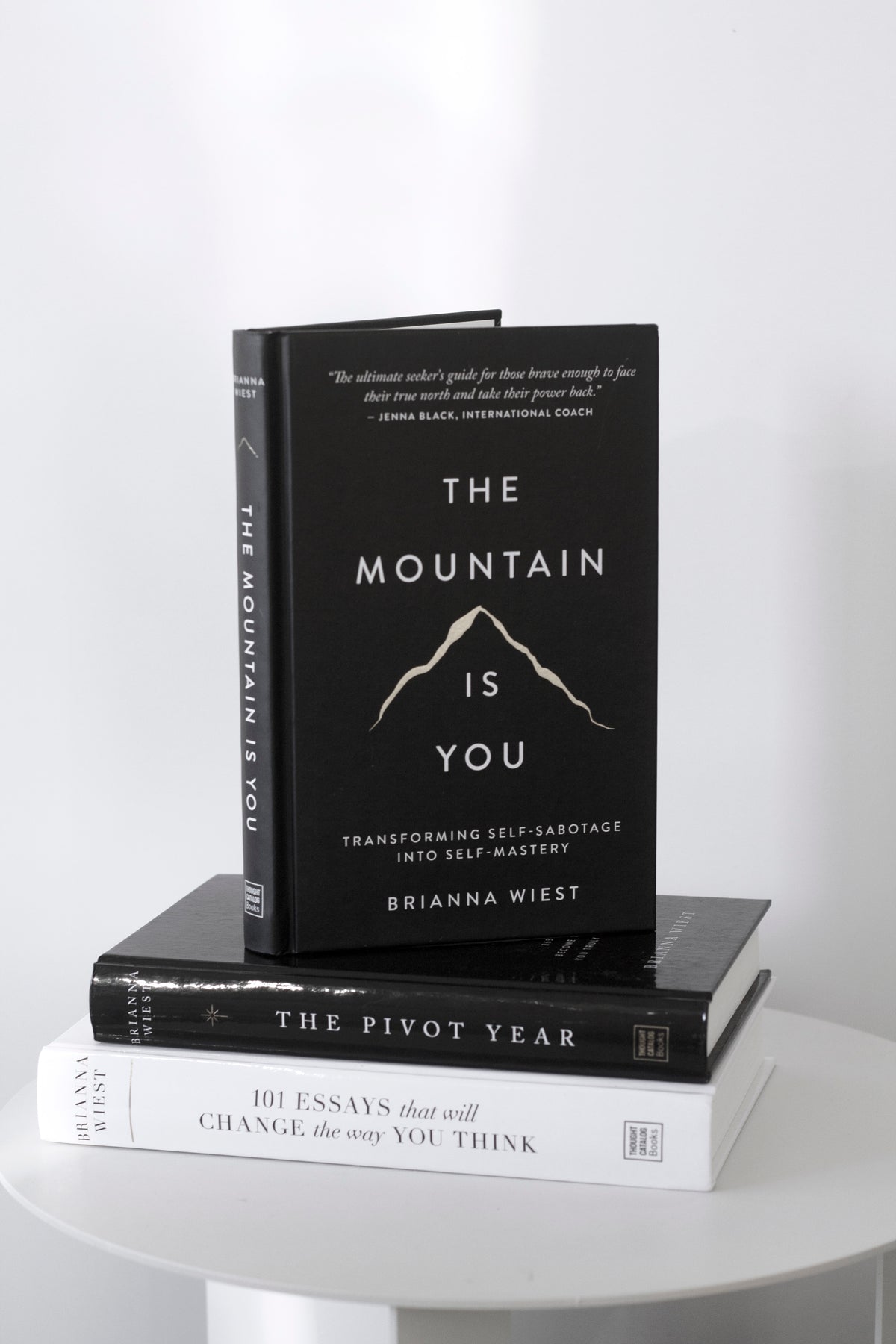 The Mountain Is You standing on a round white table above a stack of two other Brianna Wiest titles