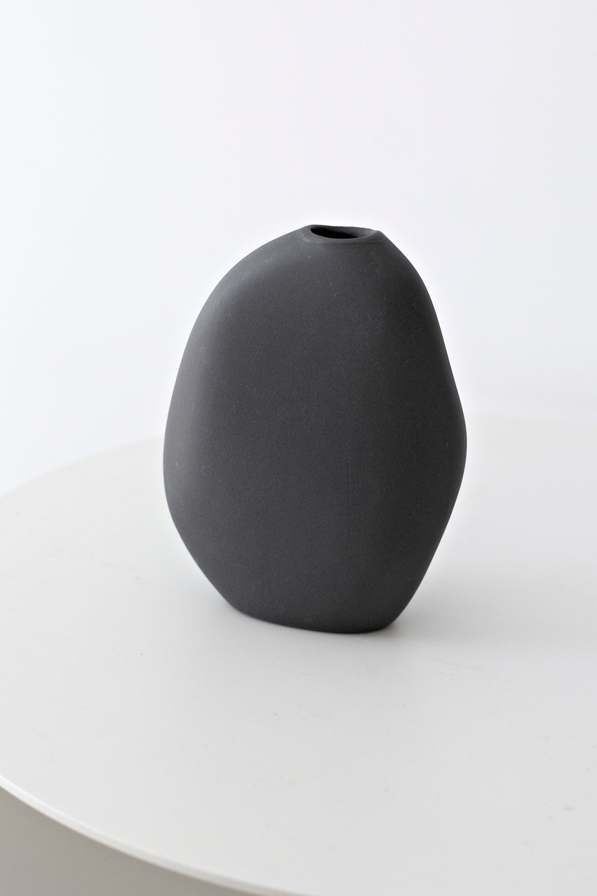 Harmie Stone Black Vase grouped with other vases at varied heights