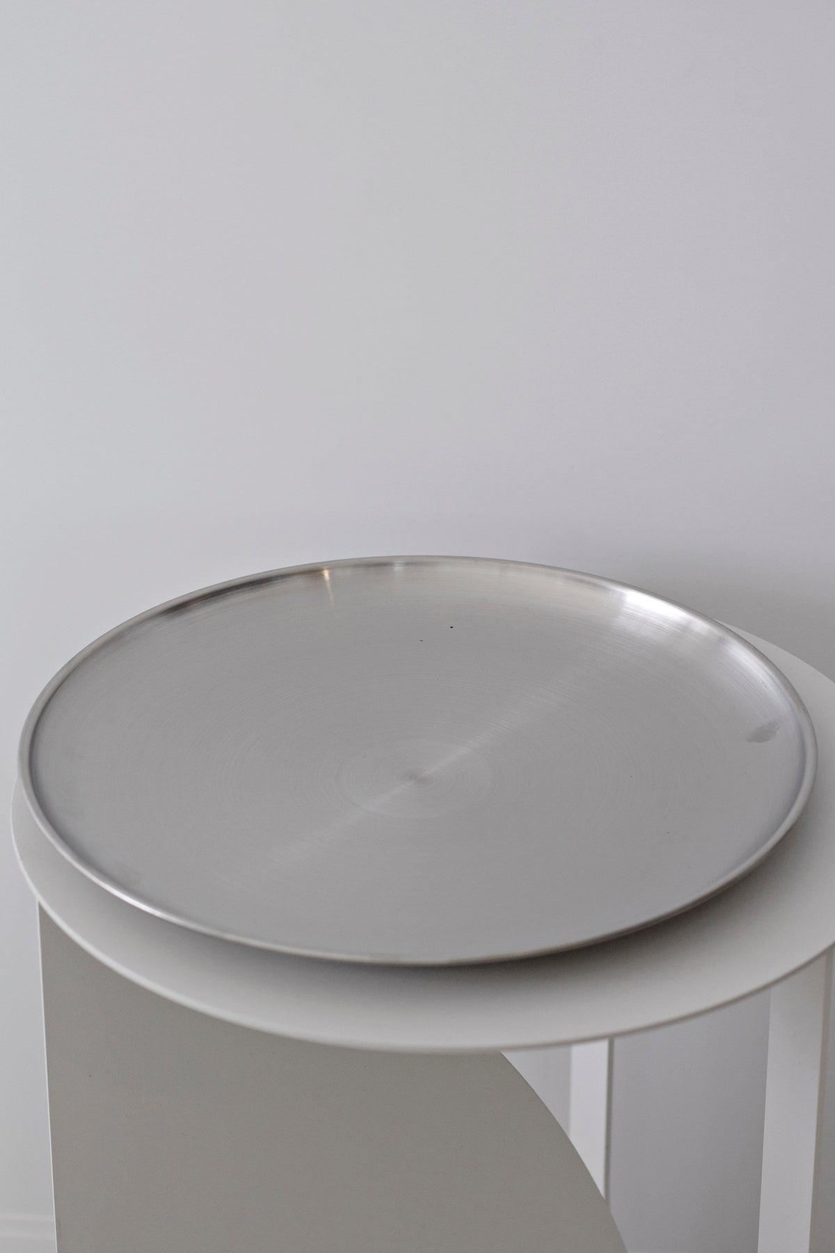 Round Stainless Steel Decor Tray holding perfume and candle