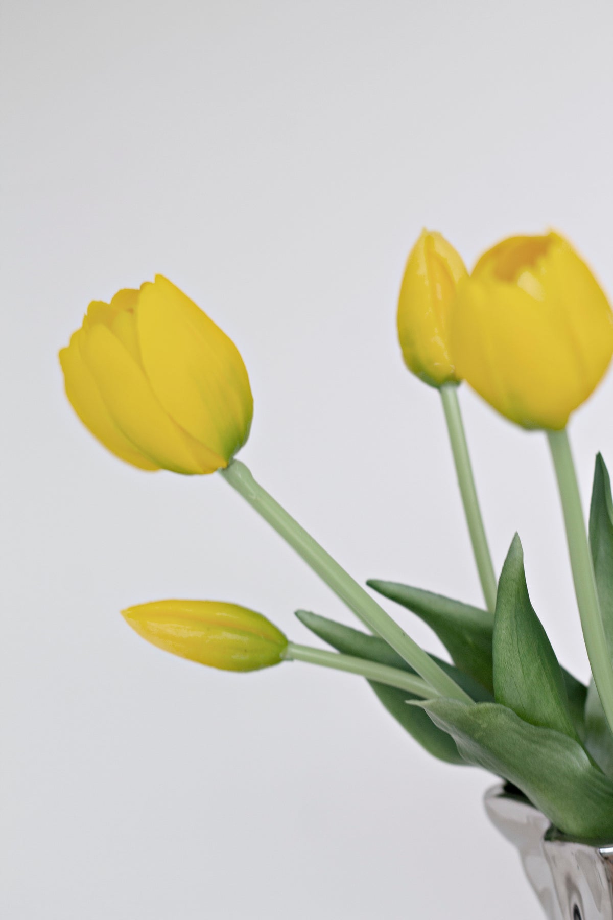 Close-up of yellow faux tulip heads and stems