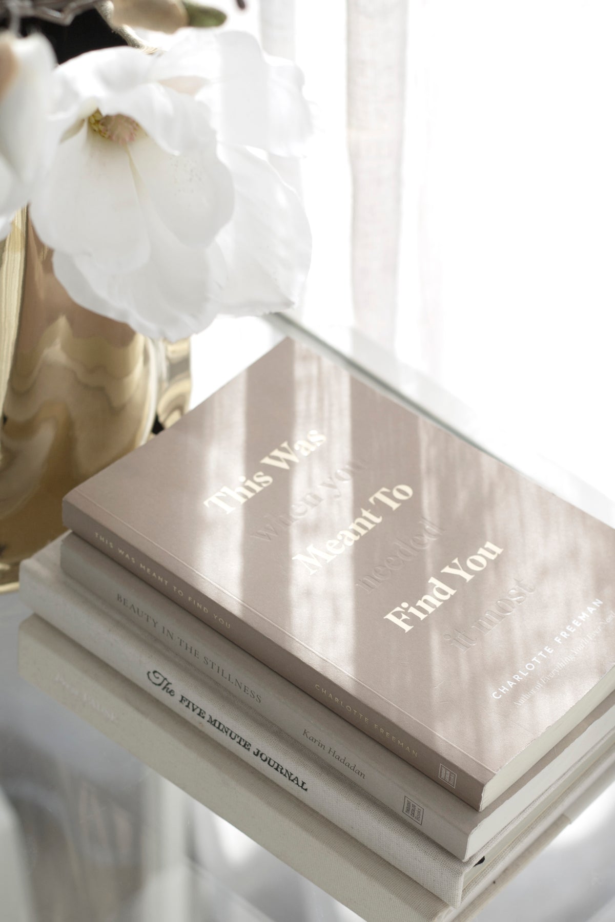 This Was Meant To Find You by Charlotte Freeman styled with white roses in a ribbed glass vase