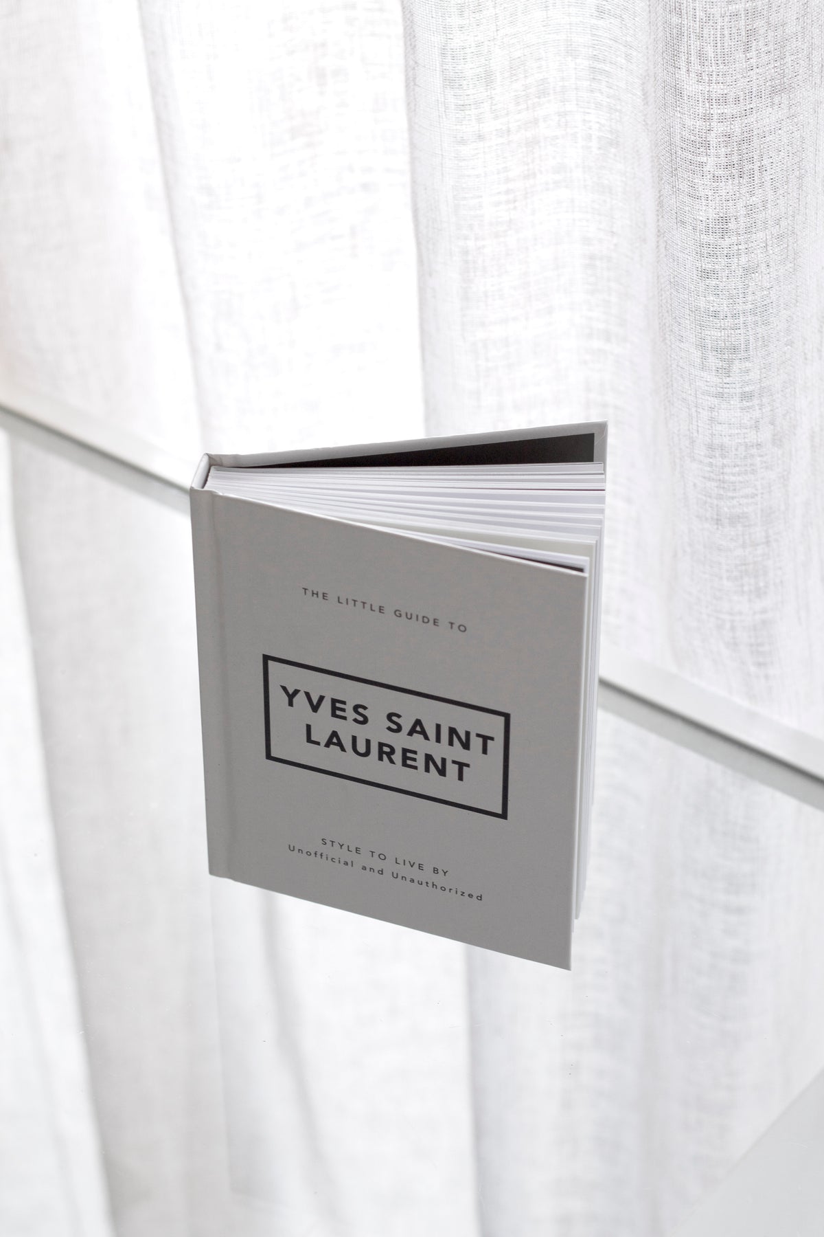 Little Guide to Yves Saint Laurent styled on a coffee table