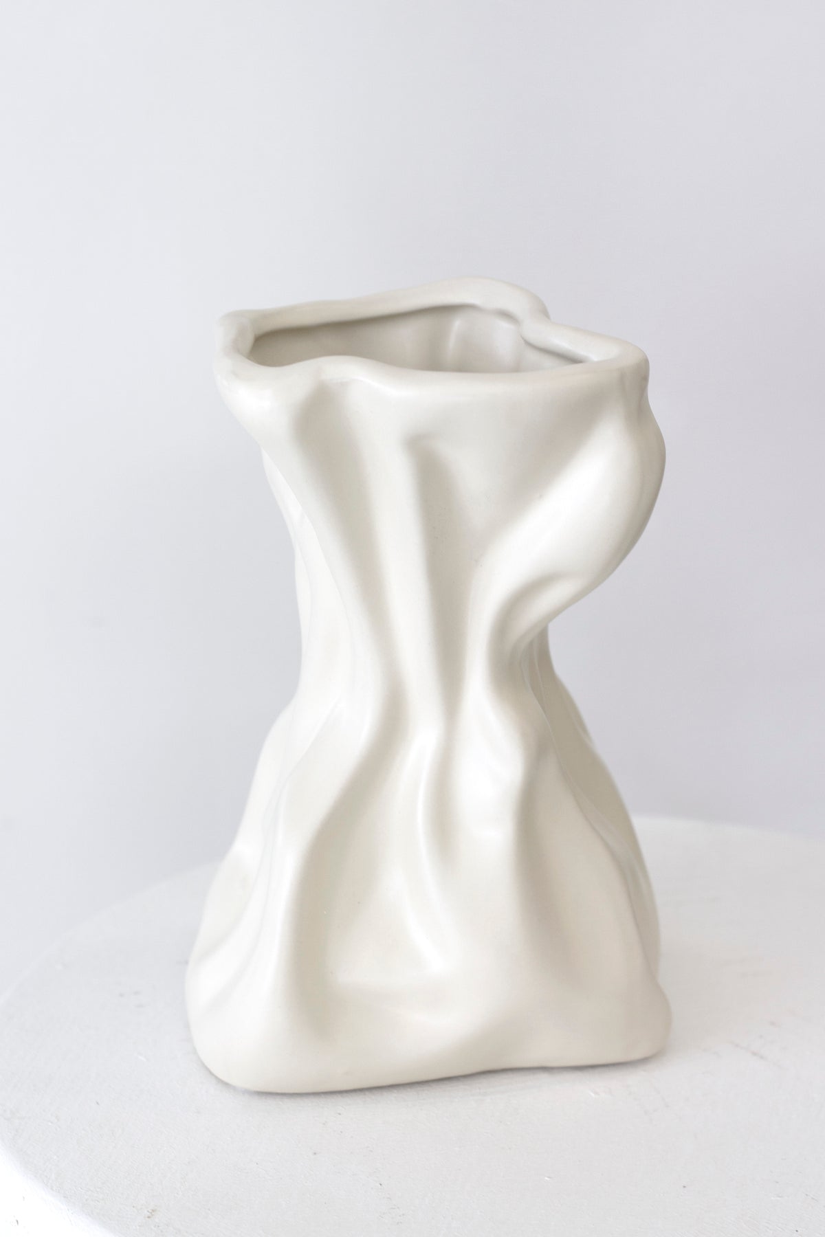 Cream crinkle vase front on against a soft white background