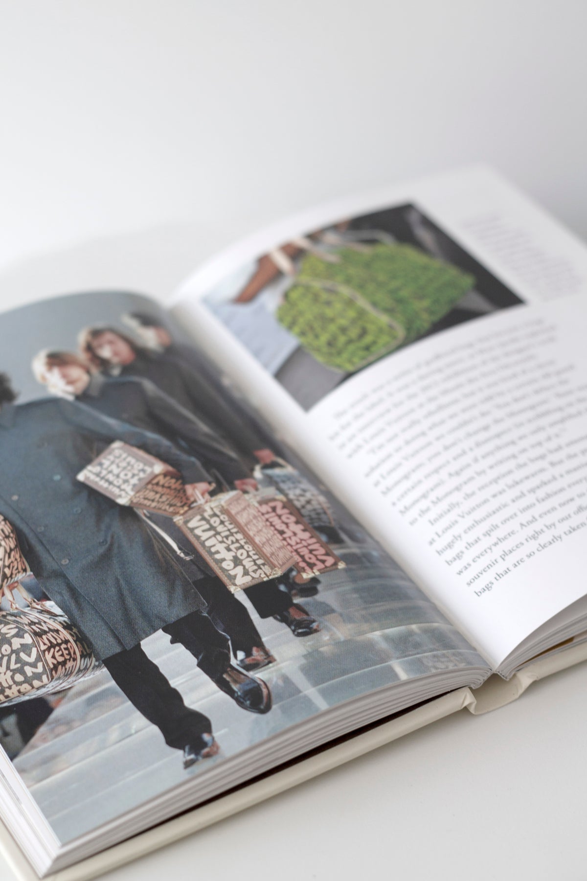 Little Book of Louis Vuitton stacked with other fashion titles on a coffee table
