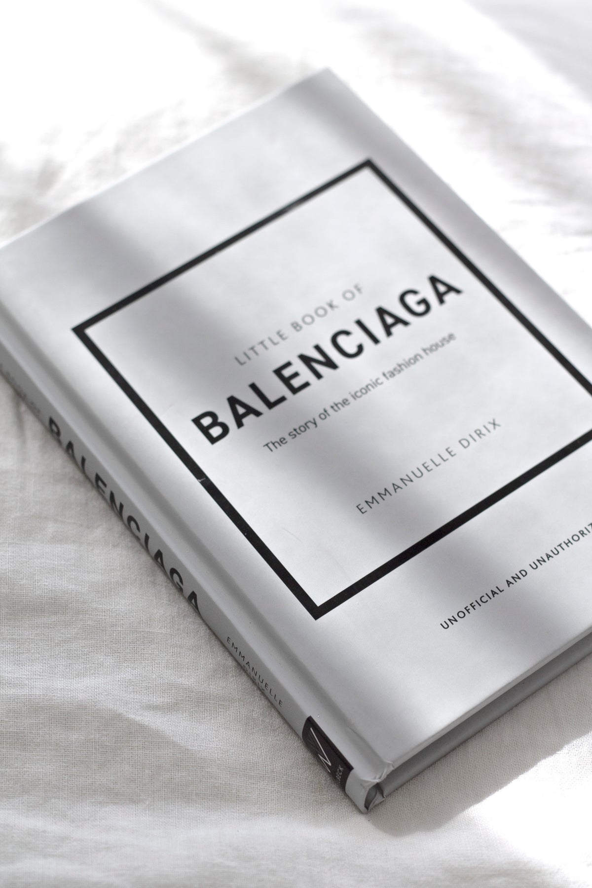 Little Book of Balenciaga styled on a neutral surface