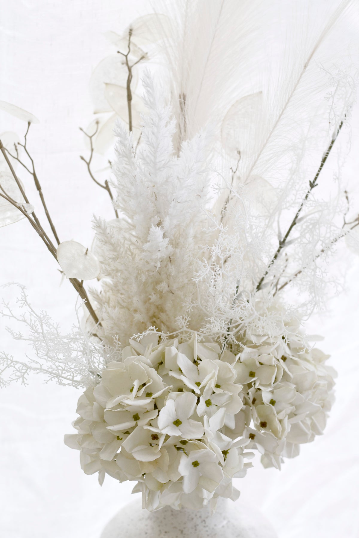Close view of the cream arrangement, astilbe plumes above white hydrangea heads