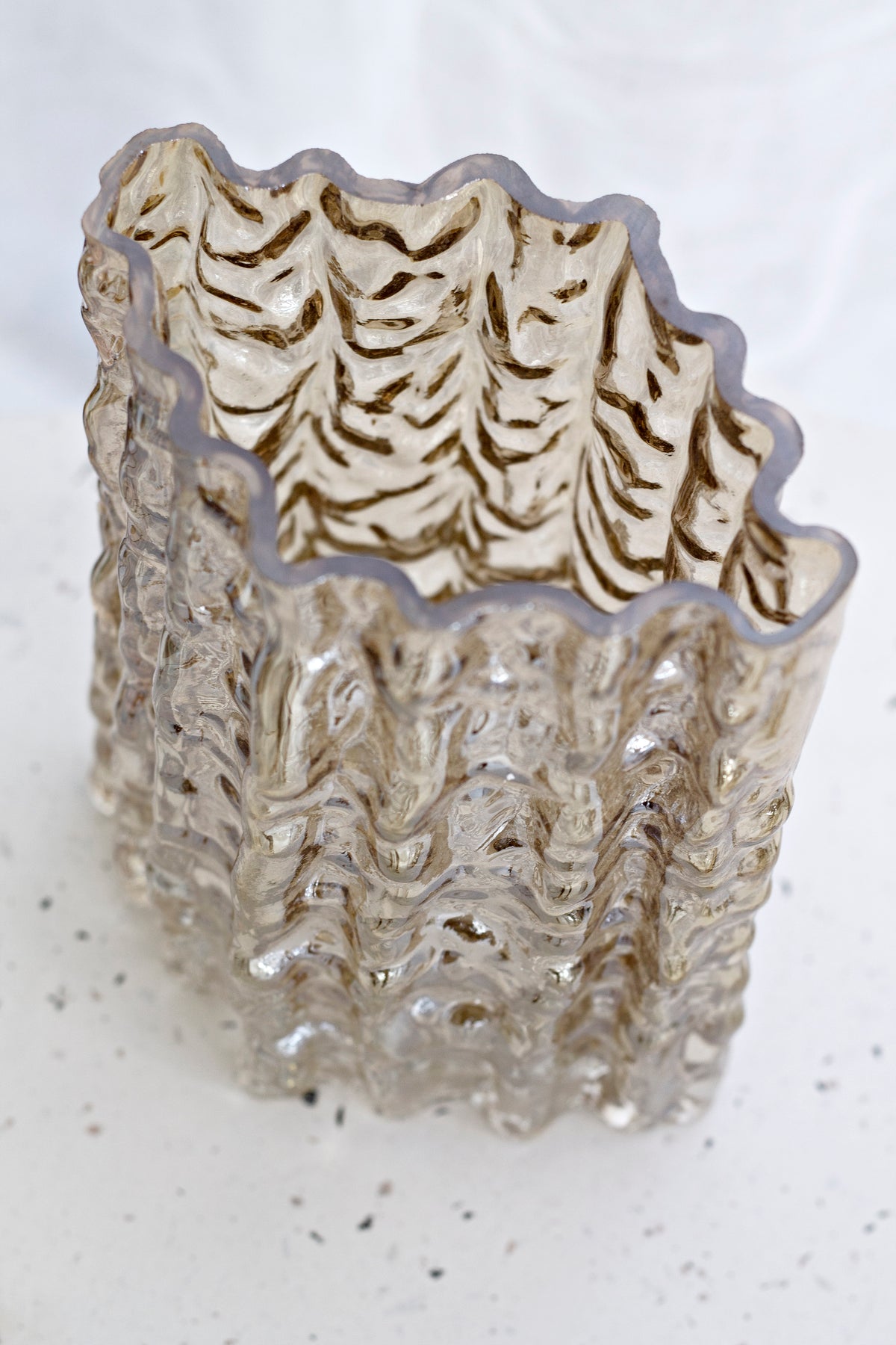 Gold Glacier vase photographed close from above, warm light across the folded rim