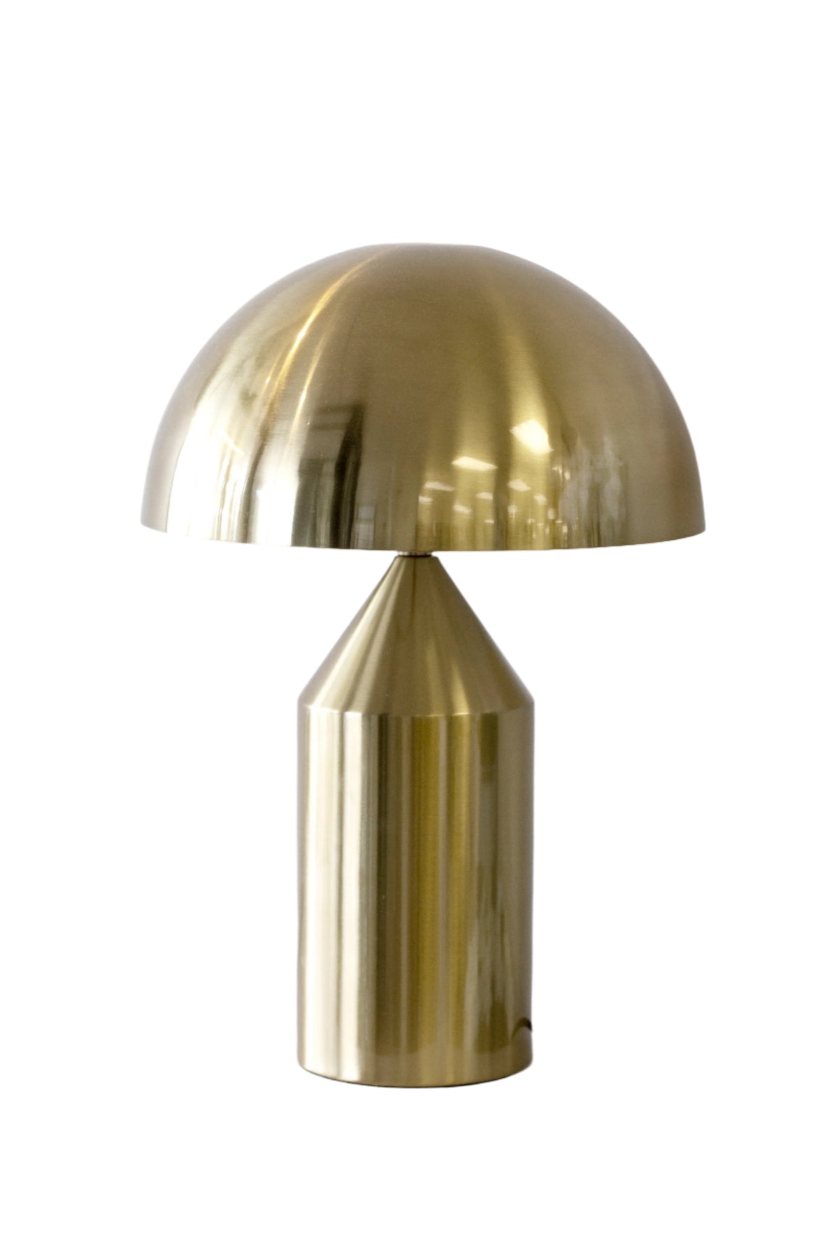 Brass dome table lamp with a polished half-round shade on a tapered cylindrical base, on white
