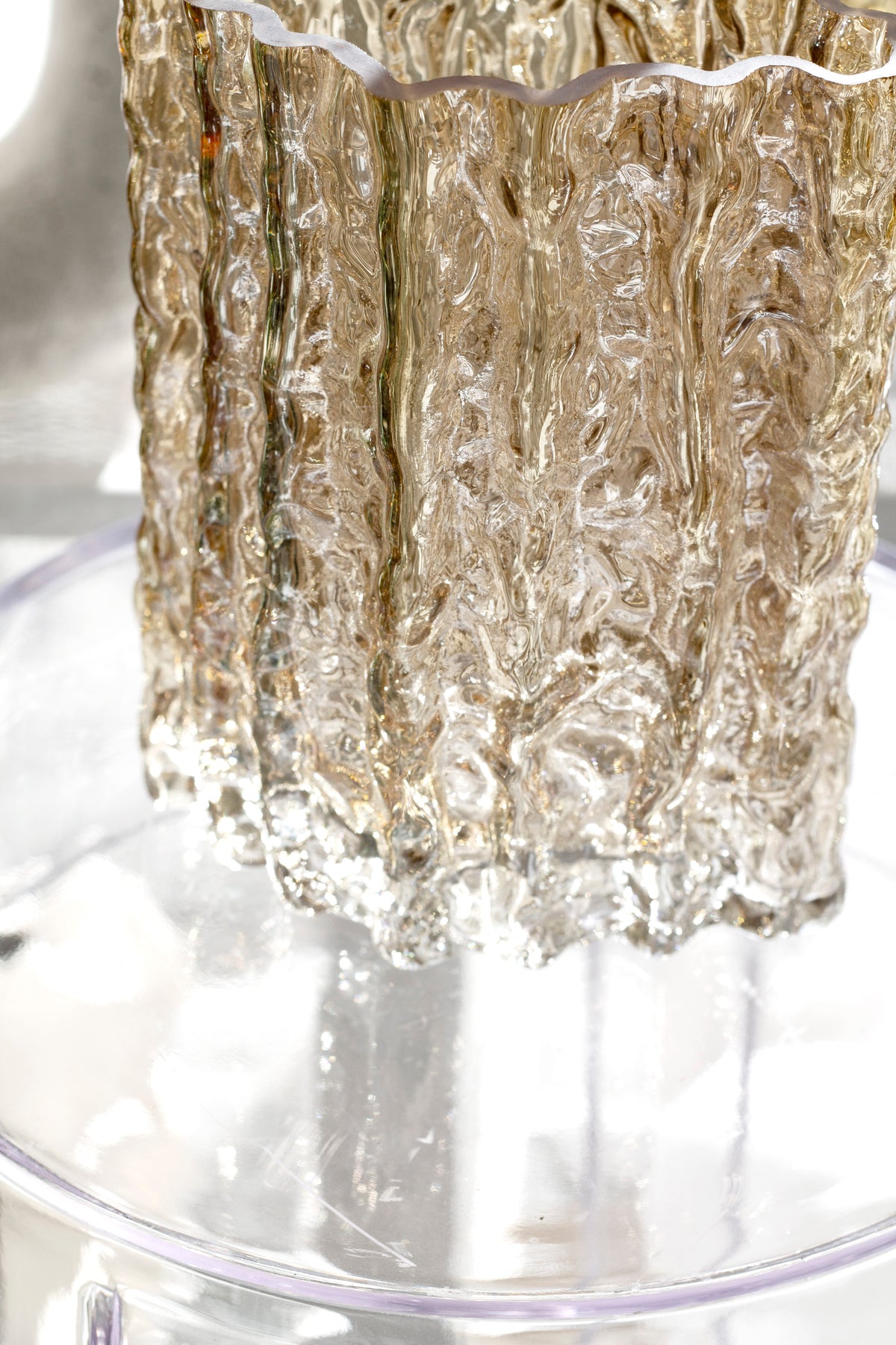 Extreme close up of the gold Glacier vase showing its molten rippled glass wall