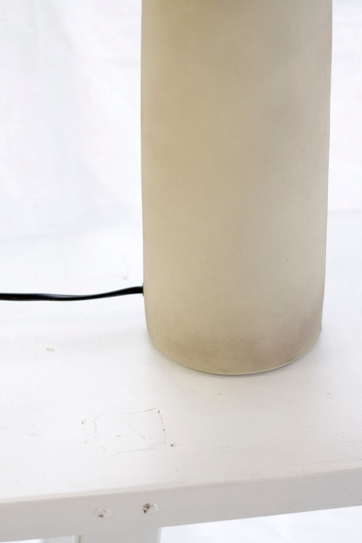 Close view of the lamp base on a white table