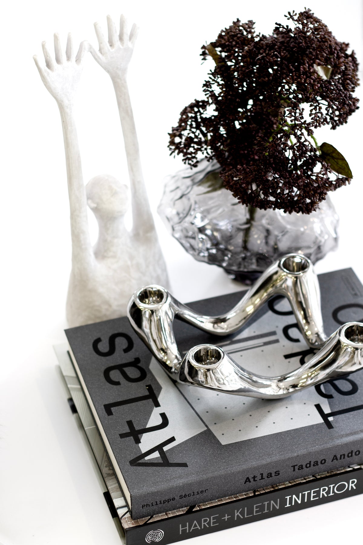 Hare + Klein Interior book styled on a coffee table with home decor