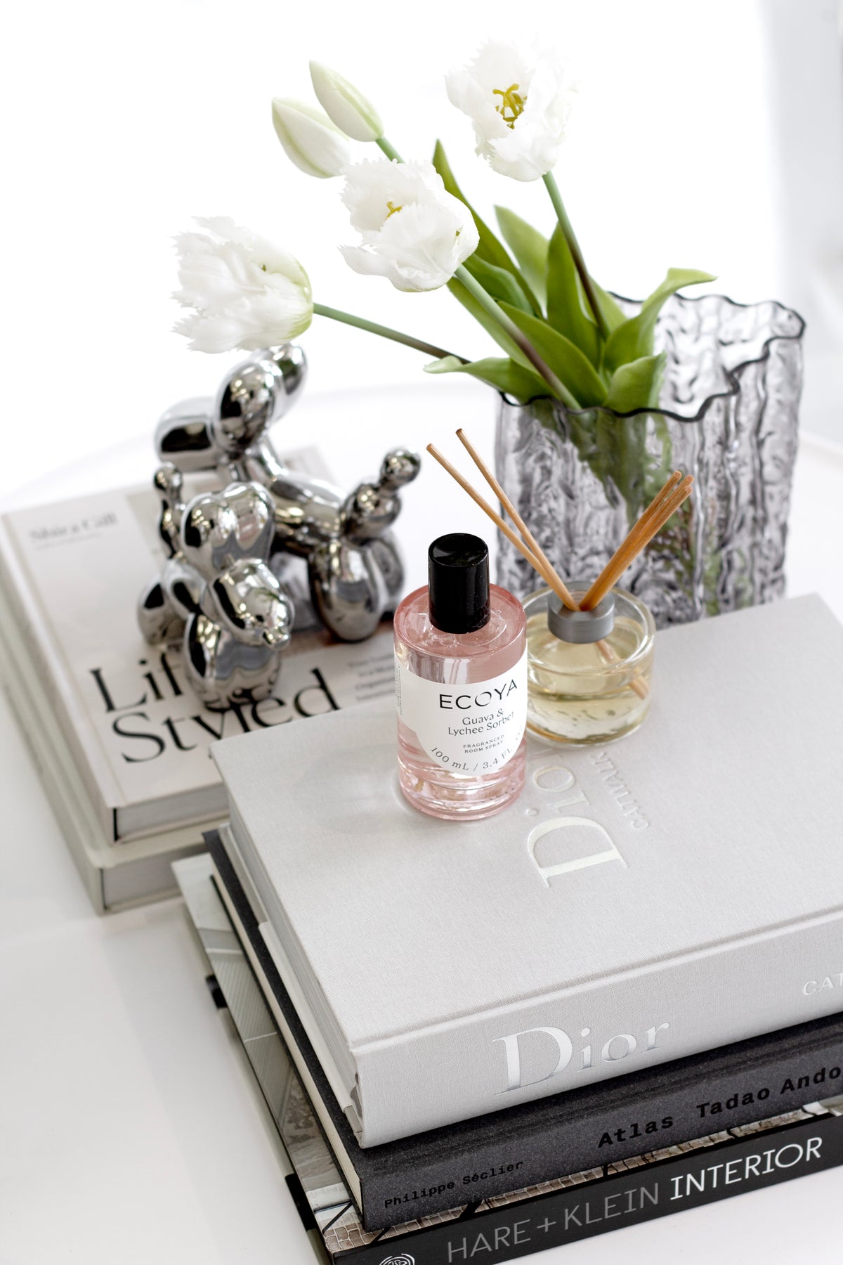 Dior Catwalk book styled on a console table