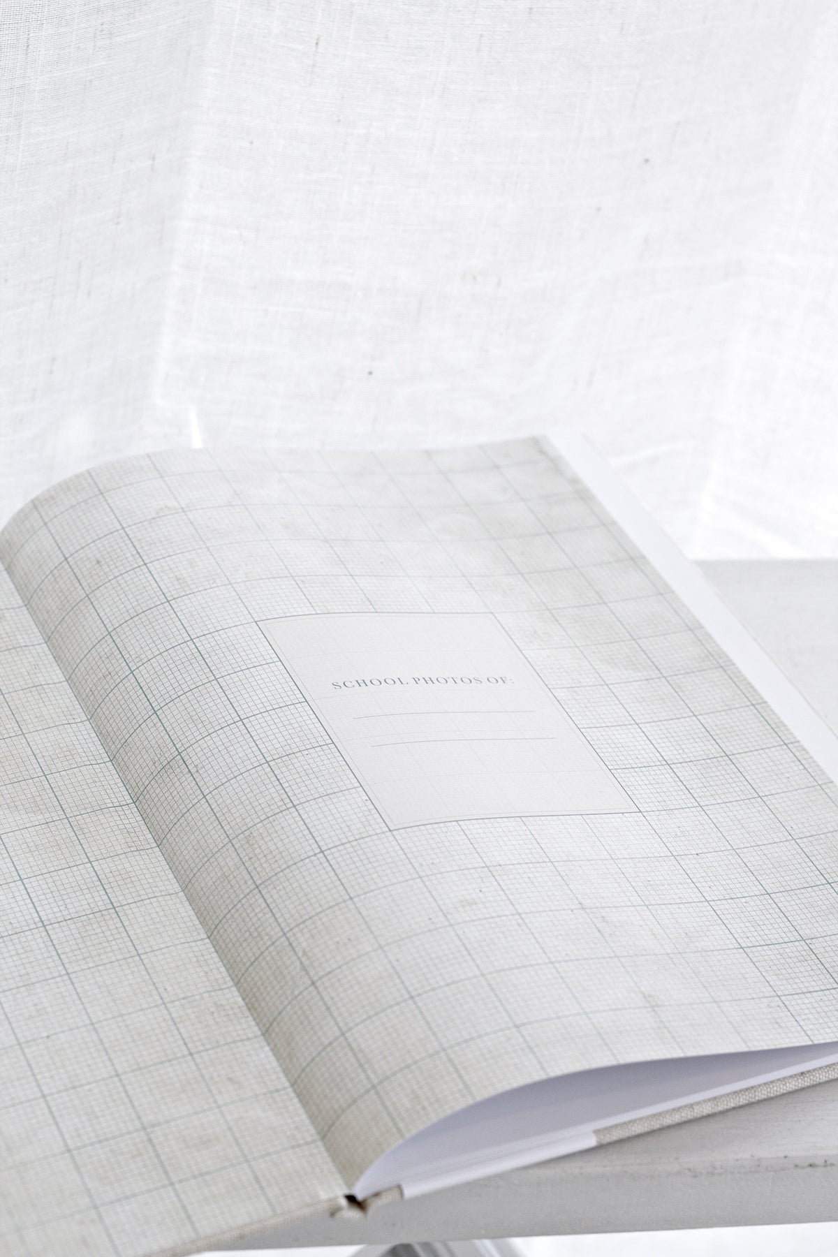 School Photos journal open to its lightly patterned endpapers