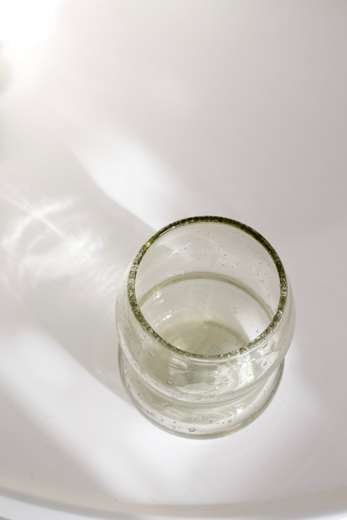 Light amber tumbler seen from above with bubbles in the glass