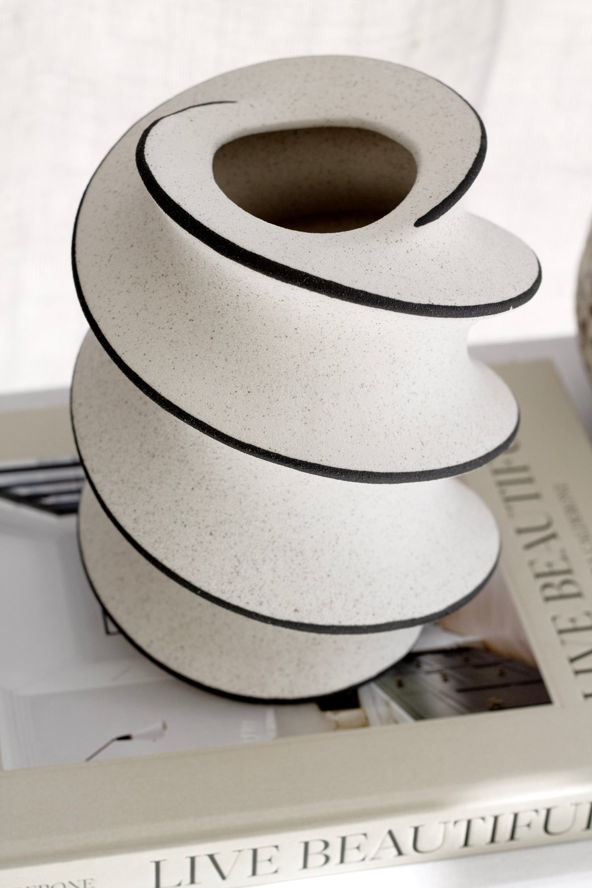 Spiral ceramic vase from above, showing its opening and painted line