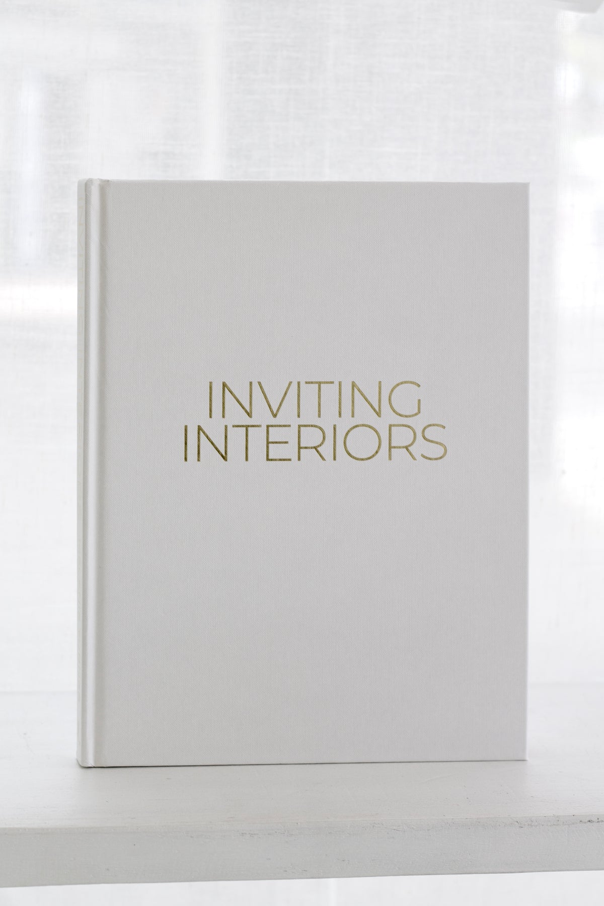 Inviting Interiors page spread showing a neutral palette room