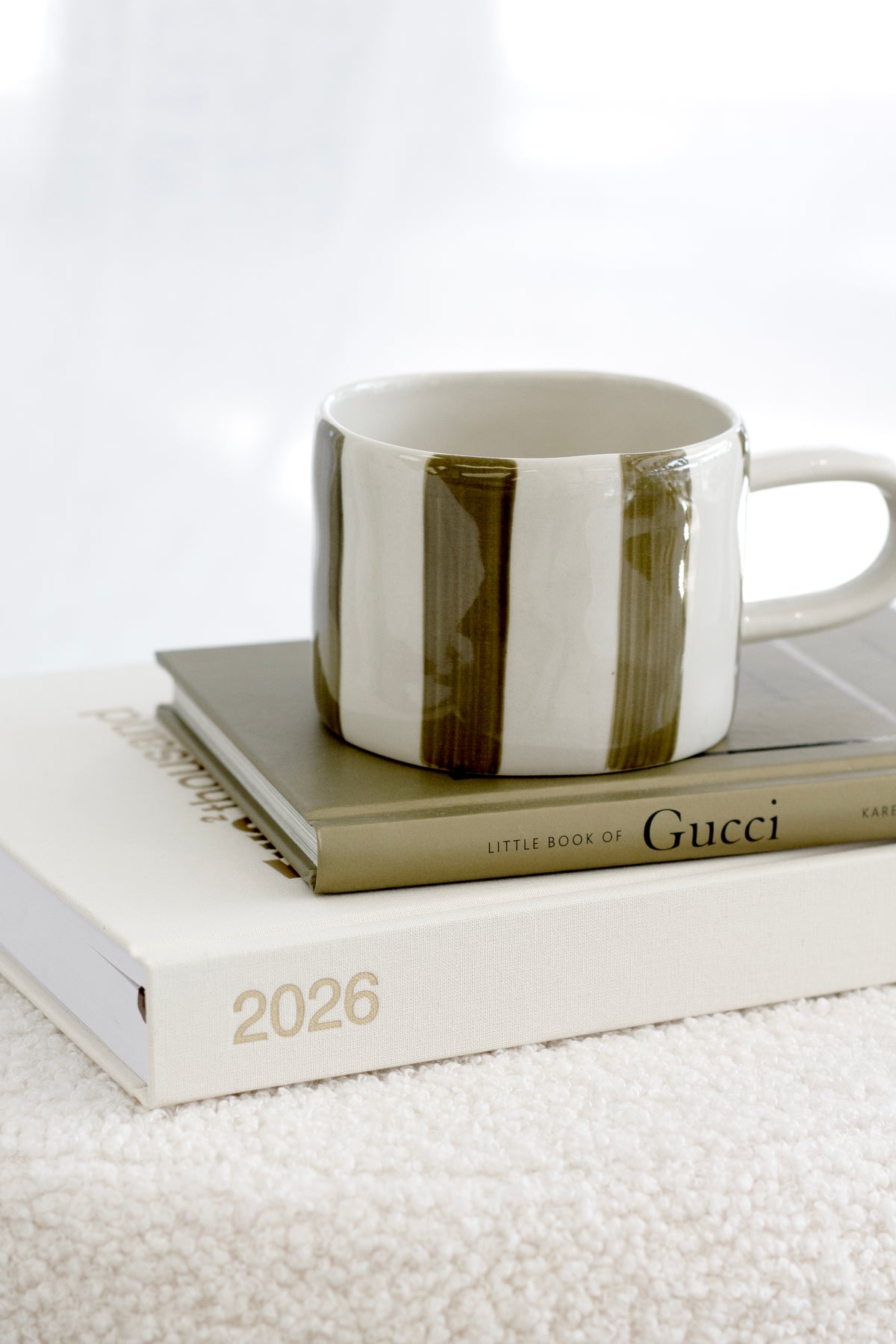 Little Book of Gucci styled on a bedside table