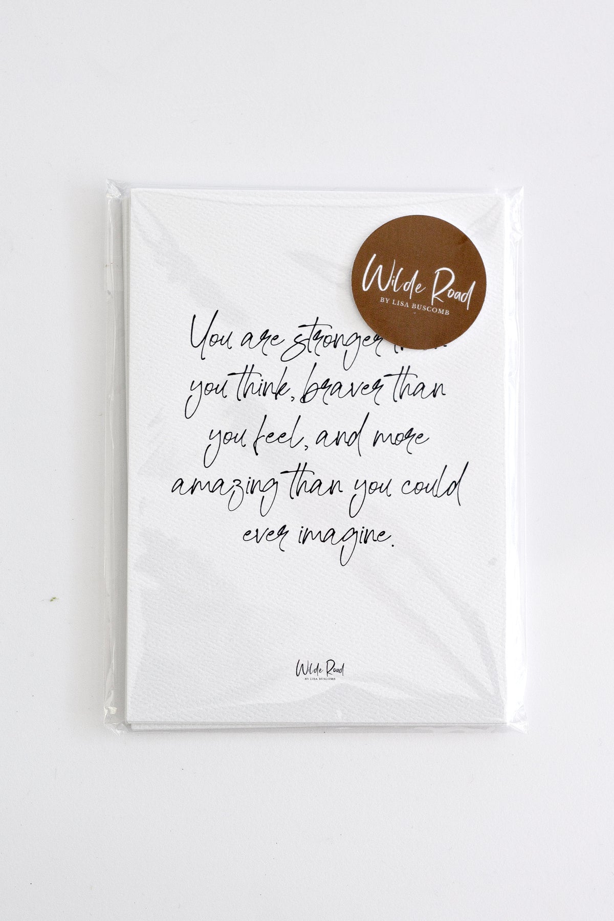 Affirmation card with a brown Wilde Road sticker on a white surface
