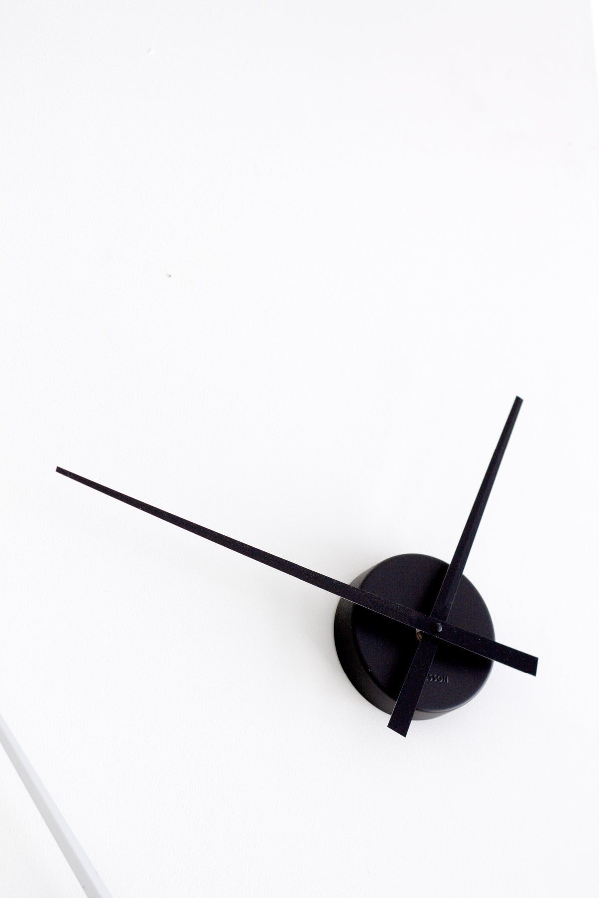 Karlsson Little Big Time Mini Wall Clock in black styled on a wall