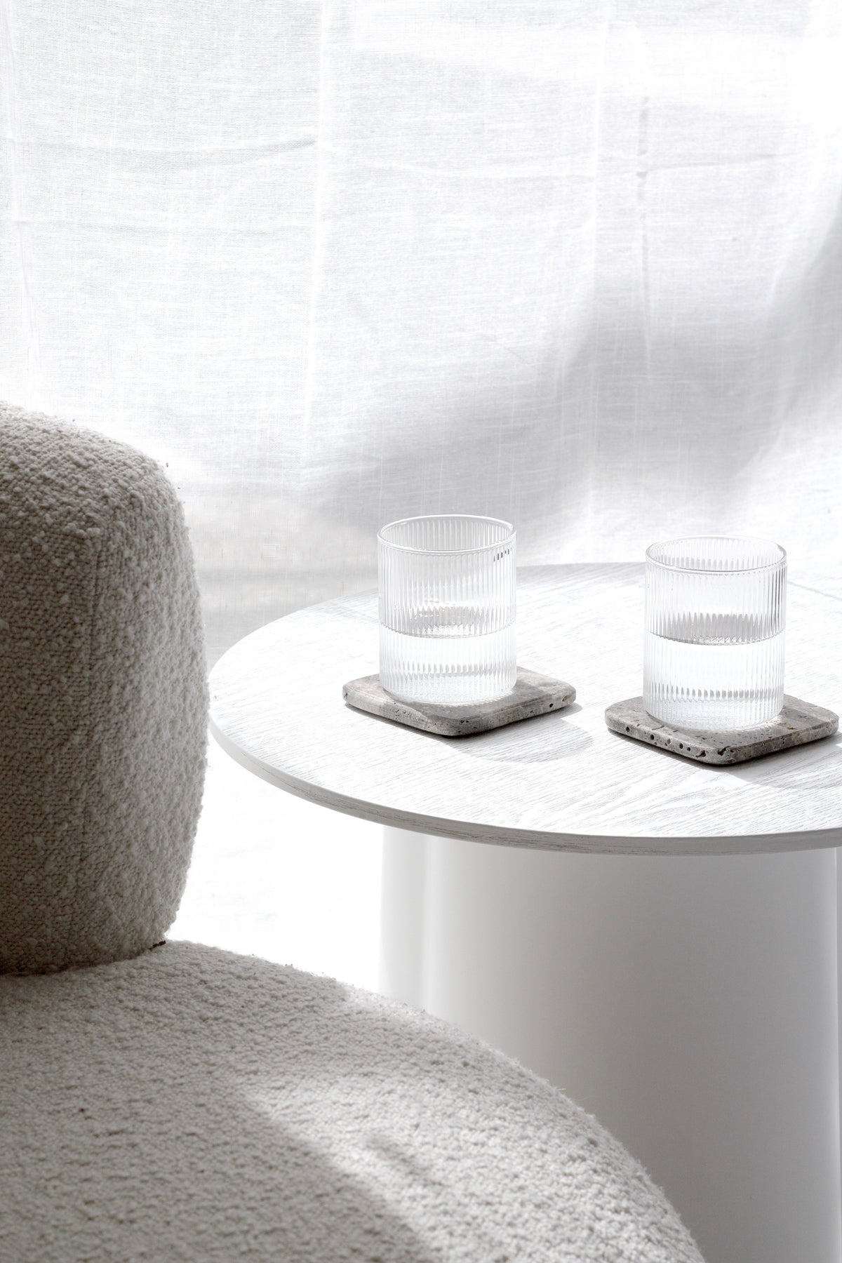 Stone coasters styled on a dining table with cutlery