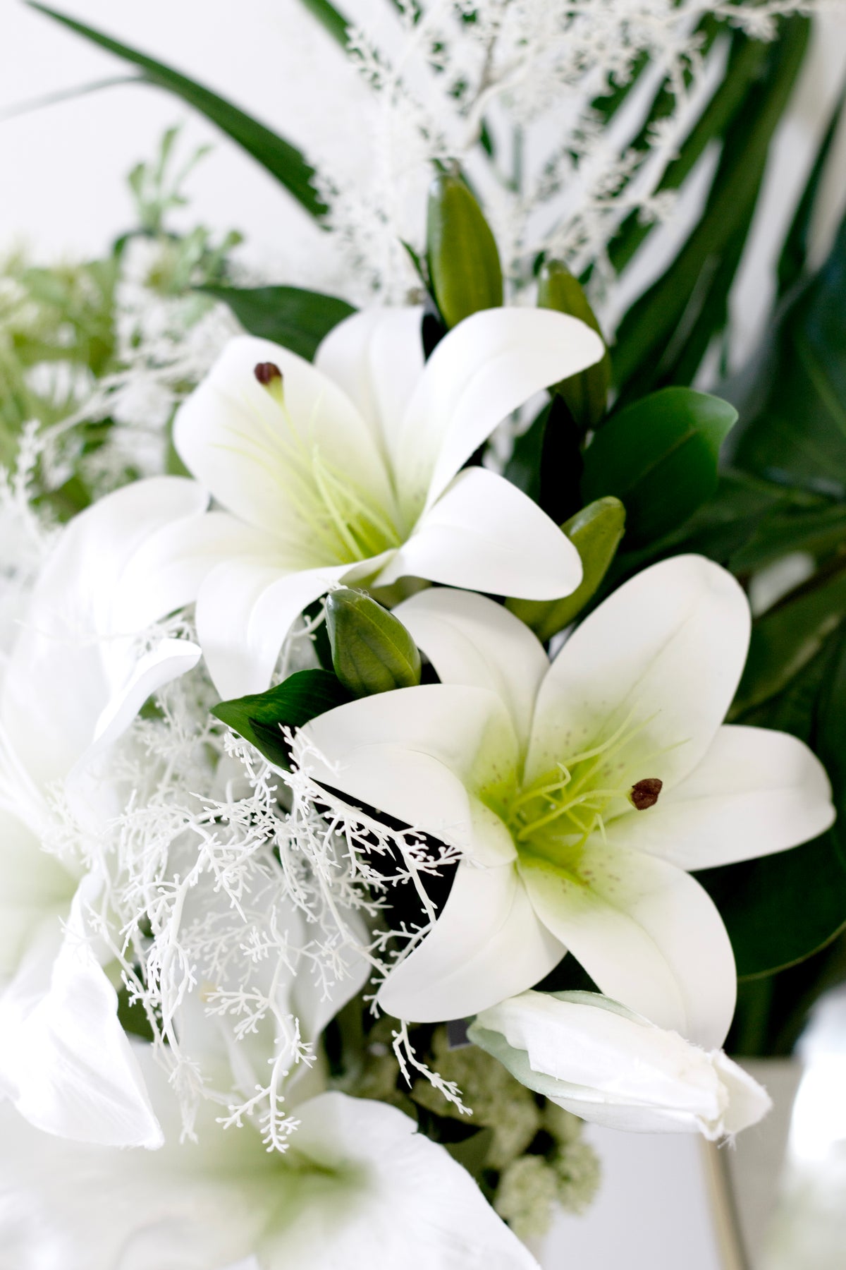 White market lilies and gypsophila in a posy, petals swept back