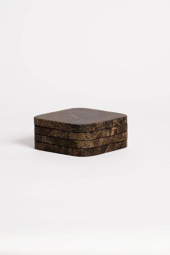 Stack of dark marble coasters on a white background