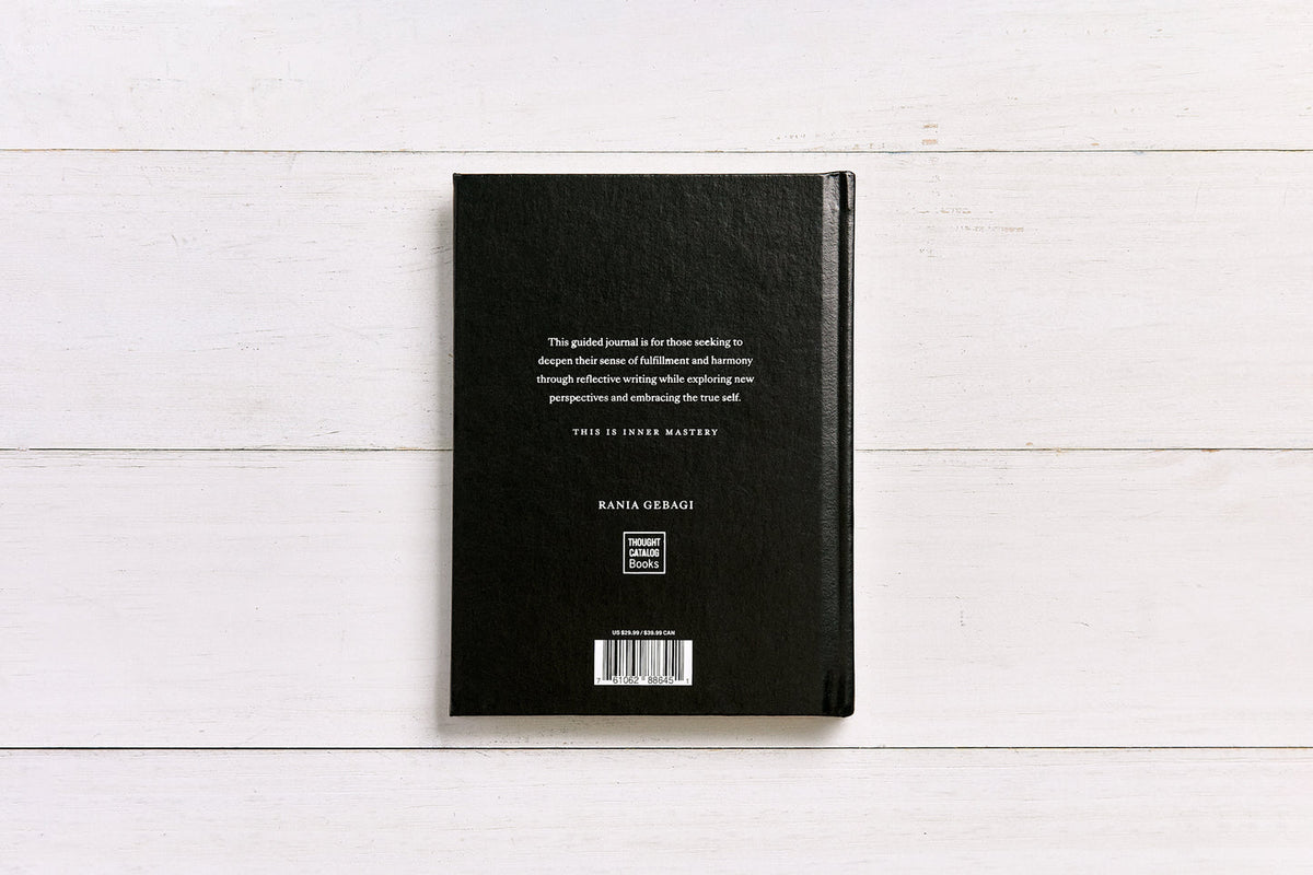 Back cover of the Inner Mastery journal on white timber