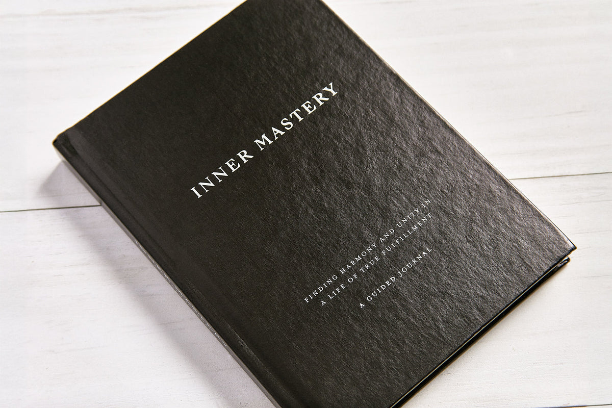Inner Mastery journal at an angle showing its textured black cover
