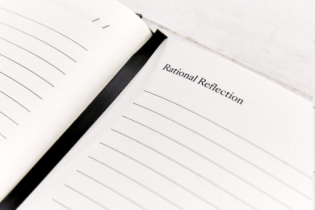 Close view of the lined Annual Reflection page and black ribbon marker