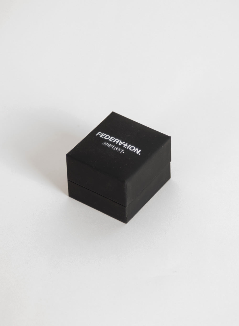 Small black Federation jewellery box on pale grey