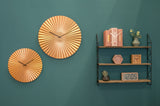 Gold Sensu fan wall clock shown from an angle