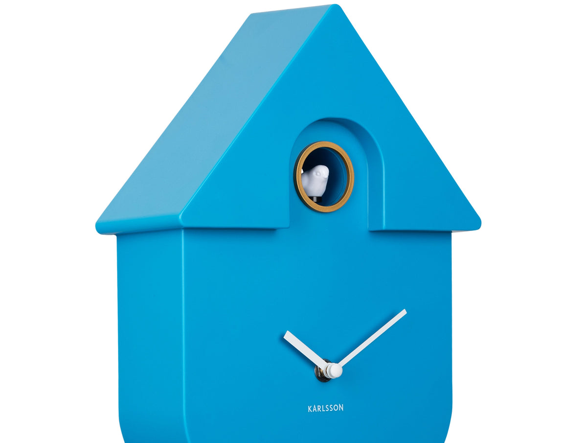Karlsson Modern Cuckoo Clock in Bright Blue, angled close-up of the case and cuckoo window