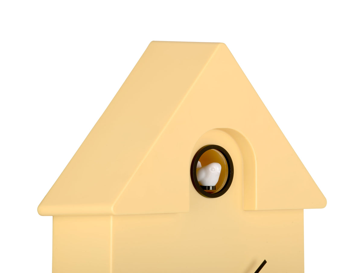 Karlsson Modern Cuckoo Clock in Soft Yellow, angled close-up of the case and cuckoo window