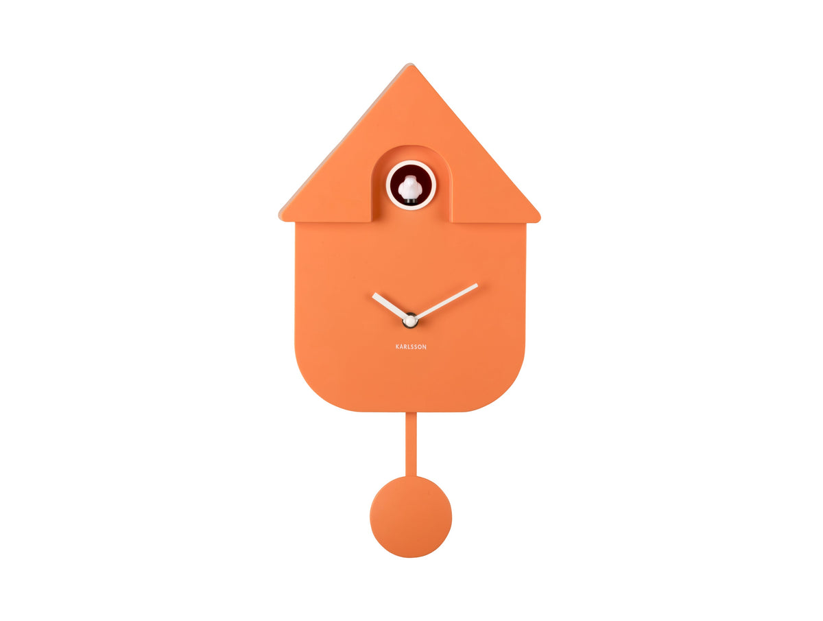Karlsson Modern Cuckoo Clock in Bright Orange, front view with pendulum on a white background
