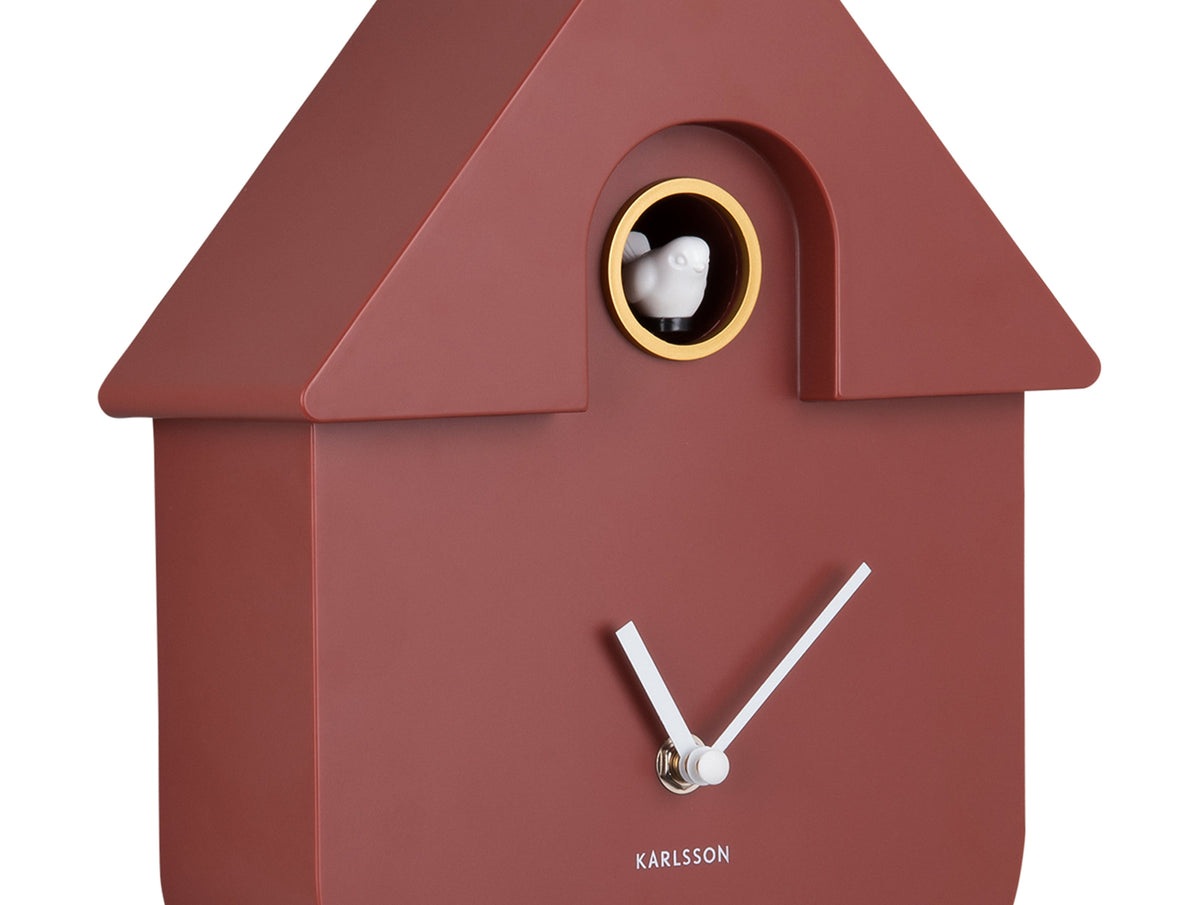 Karlsson Modern Cuckoo Clock in Red Ochre, angled close-up of the case and cuckoo window