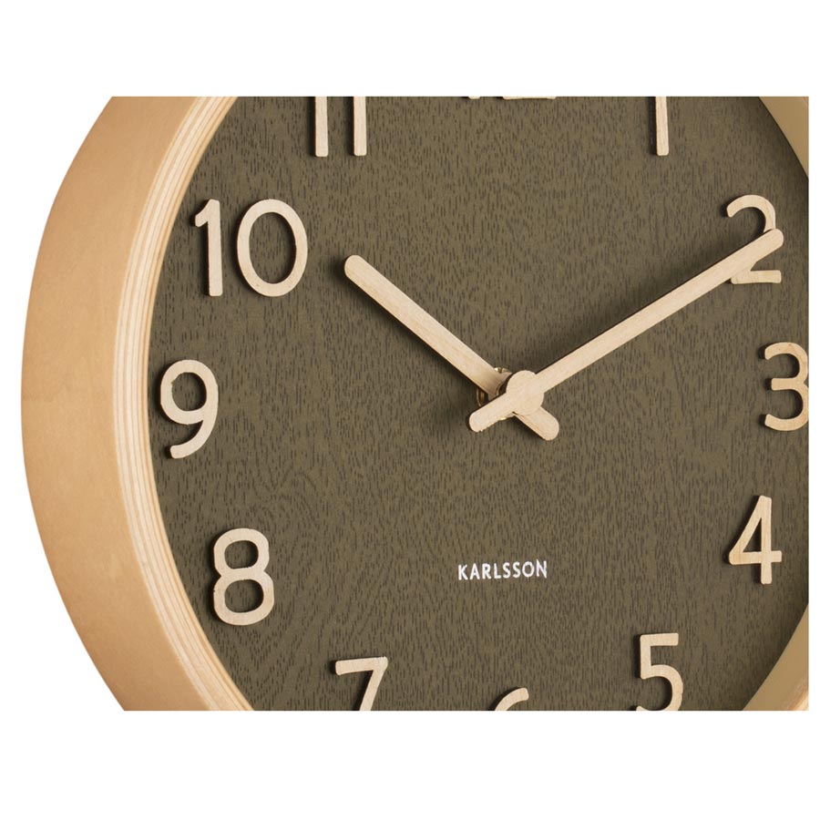 Close-up of the moss green Karlsson Pure face with timber-toned numerals and hands