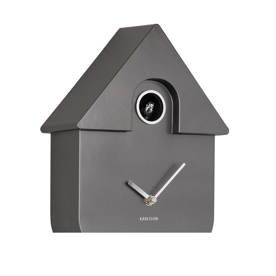 Karlsson Modern Cuckoo Clock in Metallic Dark Grey, angled close-up of the case and cuckoo window