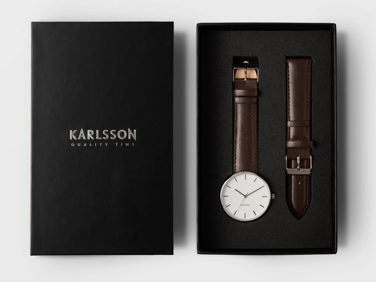 Karlsson Minimal watch in white in its black presentation box with a spare brown leather strap