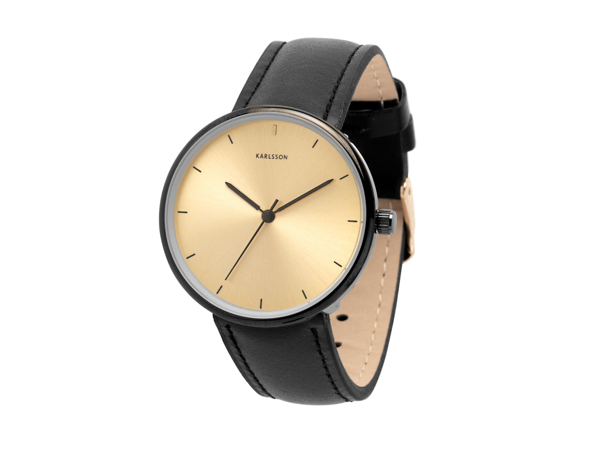 Karlsson Finesse watch with a gold dial and black leather strap, shown at an angle