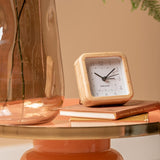 White Neat Square bamboo alarm clock styled on a bedside table