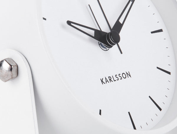 Close-up of the white Calm alarm clock dial with Karlsson logo and slim black hands