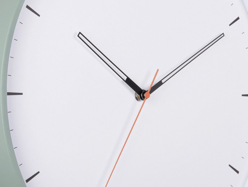 Close view of the dial, black hands and orange second hand with the case rim at the edges