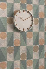 White Grace wall clock styled on a patterned wall