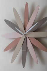 Pink Bloom petal wall clock styled on a plain wall