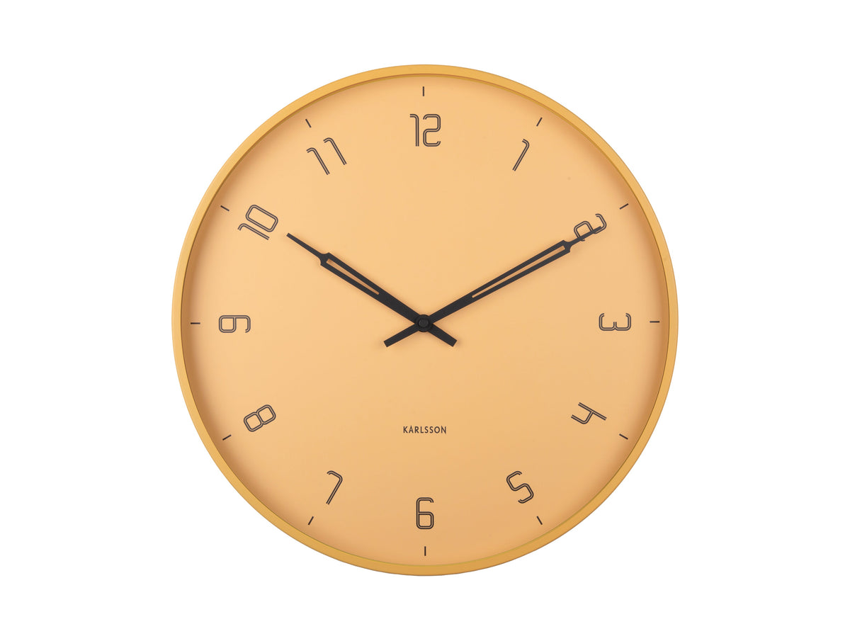 Honey yellow Stark wall clock at a slight angle on white