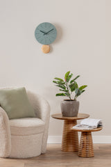 Jungle green Arlo pendulum clock styled on a living room wall