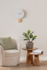 White Arlo pendulum clock styled on a living room wall