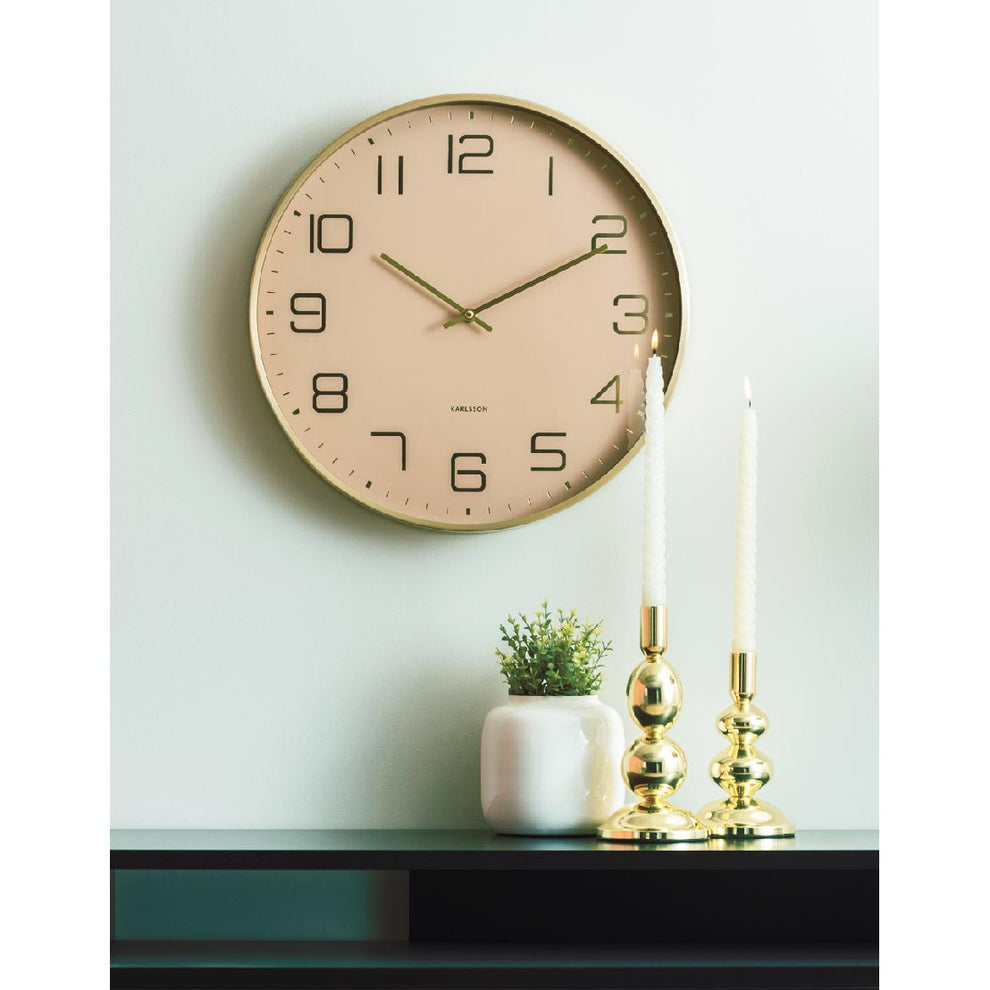 Karlsson Elegance Glow in soft brown above a black console with brass candlesticks